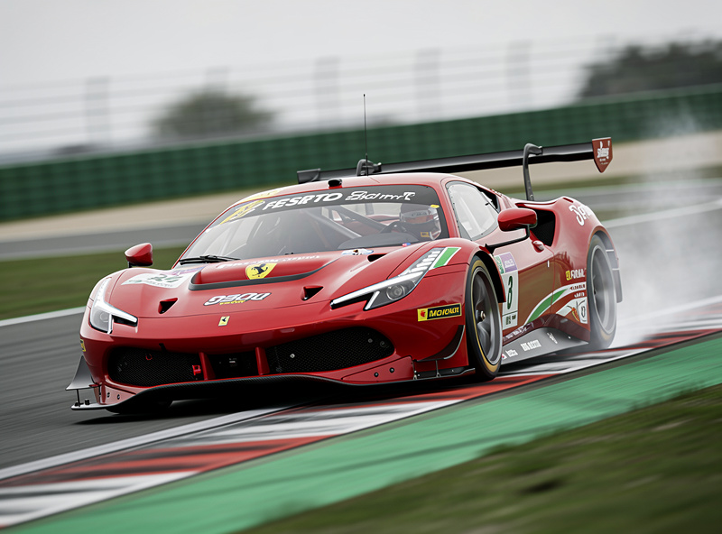 Ferrari 296 GT3 mid-corner on a racing circuit showing aggressive body stance