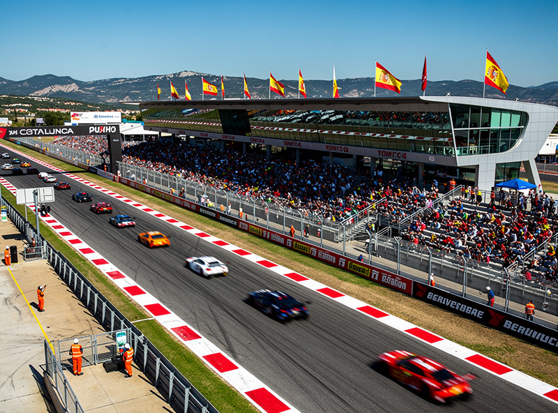Barcelona Catalunya circuit stadium section with GT cars on track