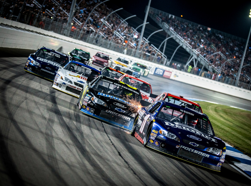 Short track racing at Bristol with cars battling through tight corners