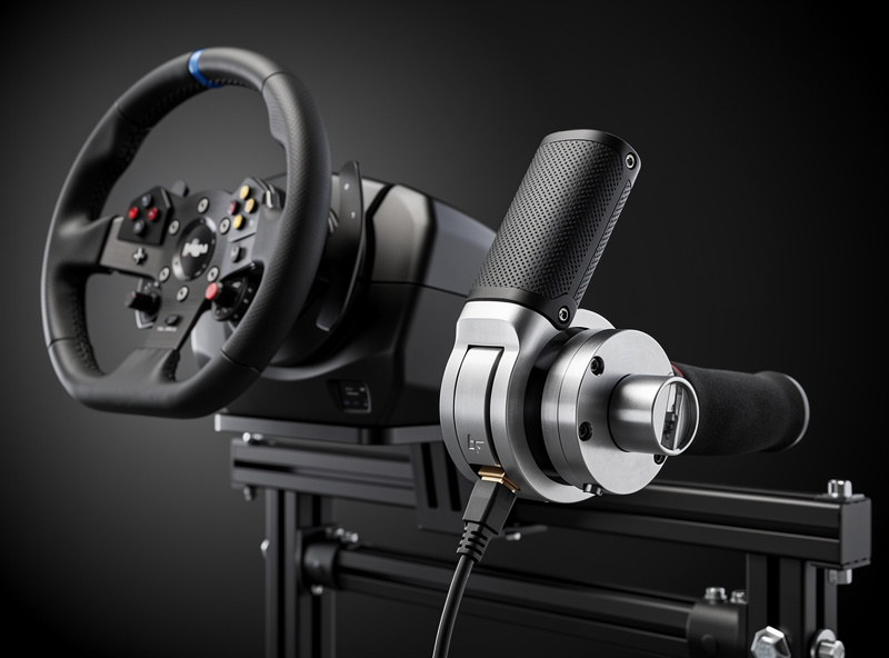 USB handbrake peripheral next to sim racing wheel on a rig