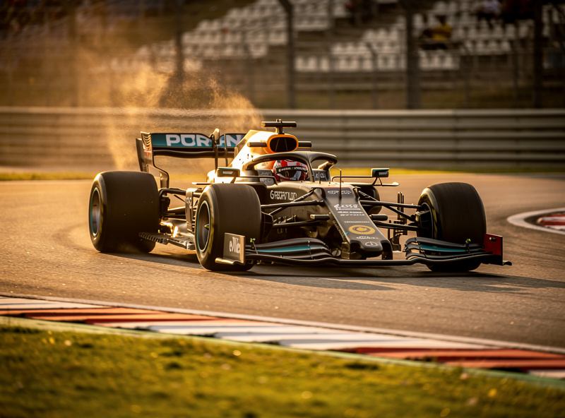Formula car racing at high speed through a sweeping corner