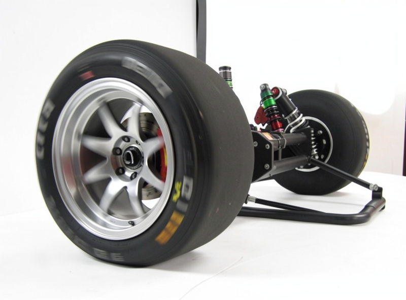 Direct-drive wheelbase on a rigid sim racing rig showing a formula-style rim under load
