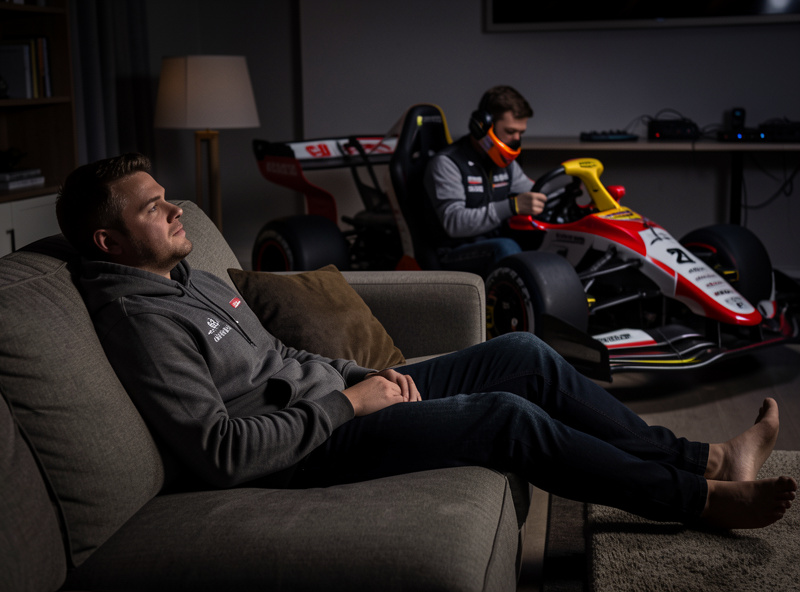 Sim racer resting between stints while a teammate drives during a long endurance race