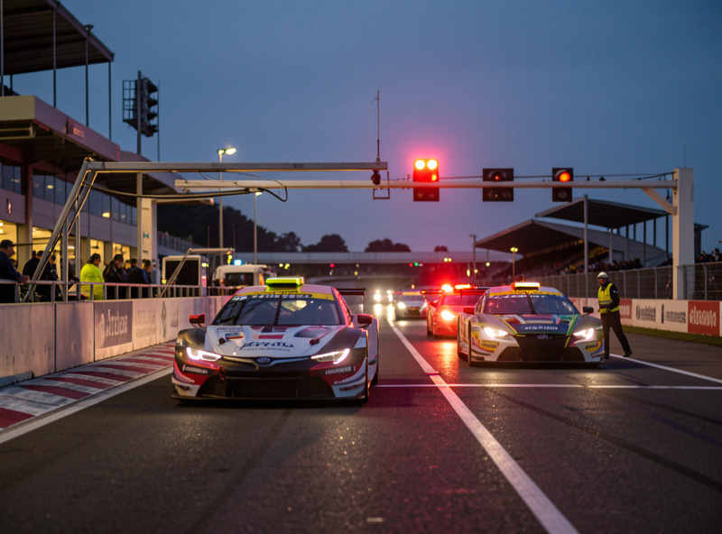 Pit lane during an endurance sim race with cars entering under a slow zone