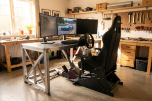 DIY sim racing cockpit rig with welded steel and aluminum profile frame, triple monitors and load-cell pedals in a home workshop