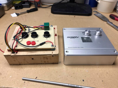 A DIY Arduino button box and a pre-built aluminium button box side by side