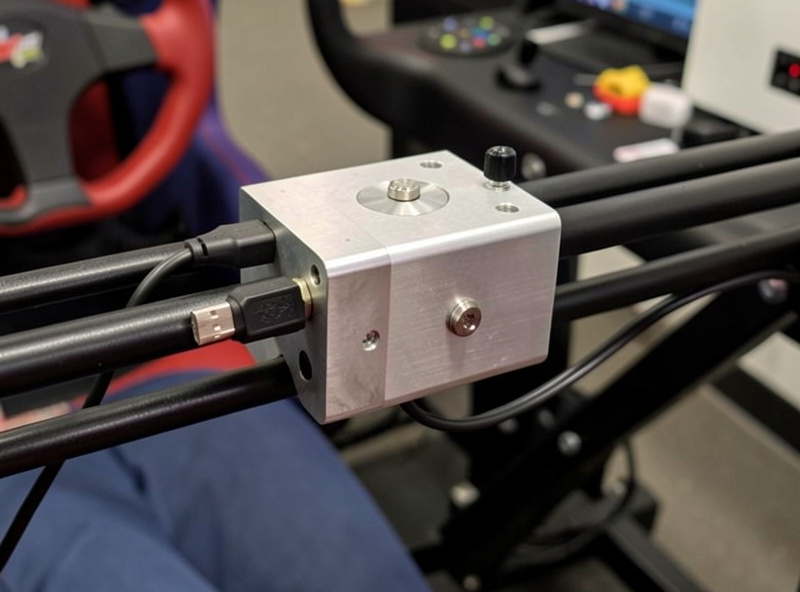 A finished DIY button box clamped to a sim racing rig rail with a neat USB cable