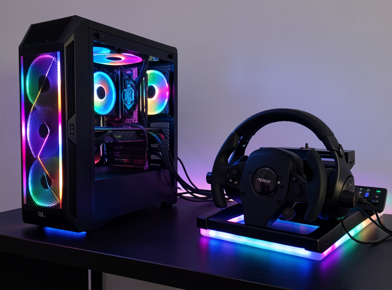 VR sim racing cockpit with a high-end PC tower visible, cables routed to the headset and direct-drive wheelbase