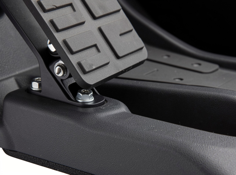 Close-up of a sim racing pedal deck wedged and bolted against a solid foot plate