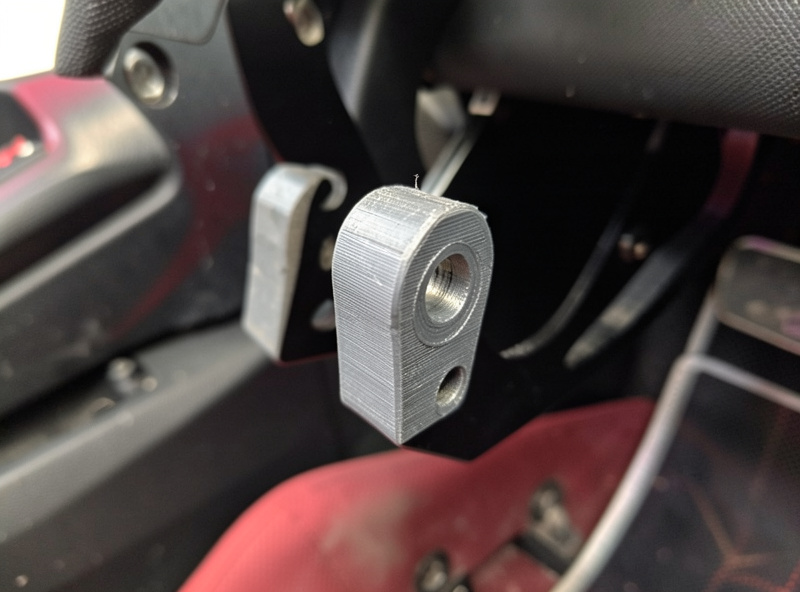 A 3D-printed PETG pedal-face spacer being fitted to a sim racing brake pedal