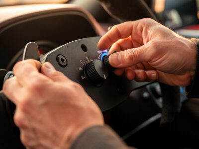 Sim racer adjusting wheelbase torque on a direct-drive base