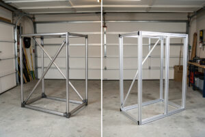 Welded steel-tube sim rig frame beside an 80/20 aluminum extrusion frame in a garage